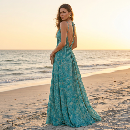 Low V-back of the aqua and teal paisley maxi dress styled for sunset on the beach